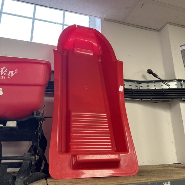 Red vintage Omega Plastic snow sled for winter fun.