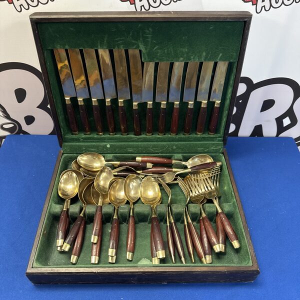 Vintage bronze coloured cutlery set displayed in its original case.