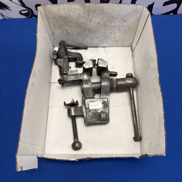 Vintage bench vice for metalworking, showing adjustable jaws and heavy base.
