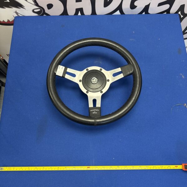 Mountney steering wheel on a blue background.