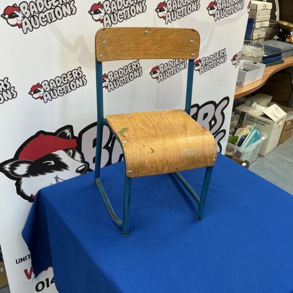 Vintage child’s chair with wooden seat and metal frame.