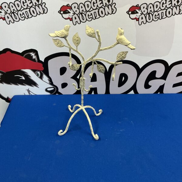 Silver tone metal bird jewellery stand for displaying necklaces and earrings.