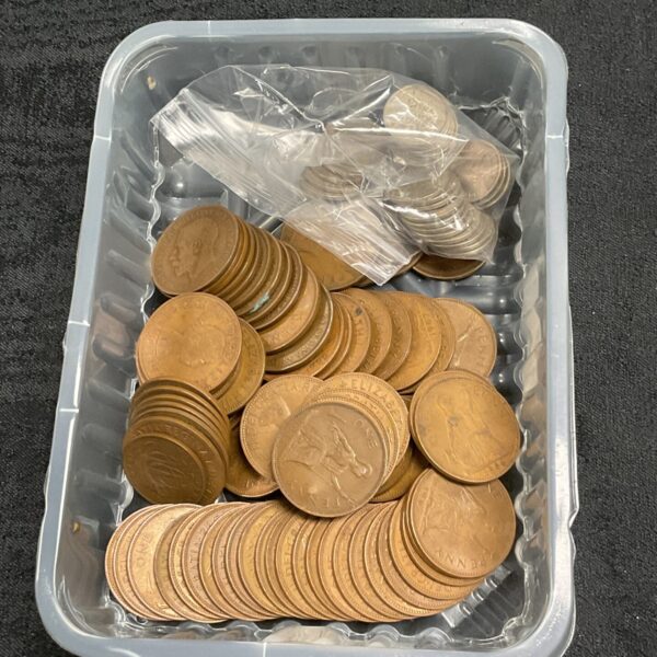 Vintage British pennies and sixpences in a plastic tub.