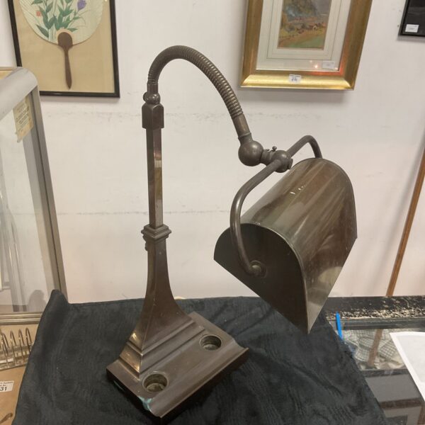 Vintage brass banker's lamp with inkwell and pen tray.