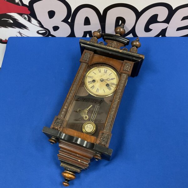 Antique German Vienna wall clock with Roman numeral face.