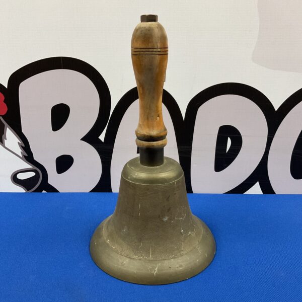 Vintage brass hand bell with wooden handle, antique collectible.