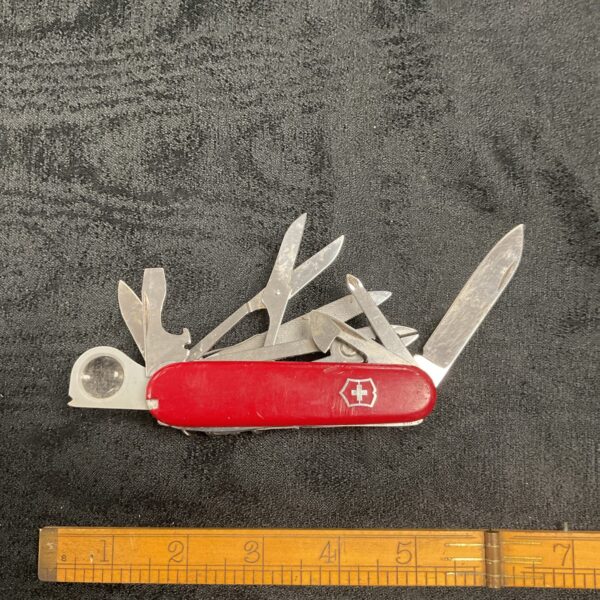 Open Victorinox Swiss Army Knife with multiple tools displayed.