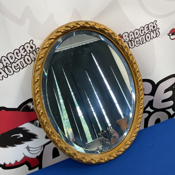 Elegant French style oval bevelled mirror with gold frame.