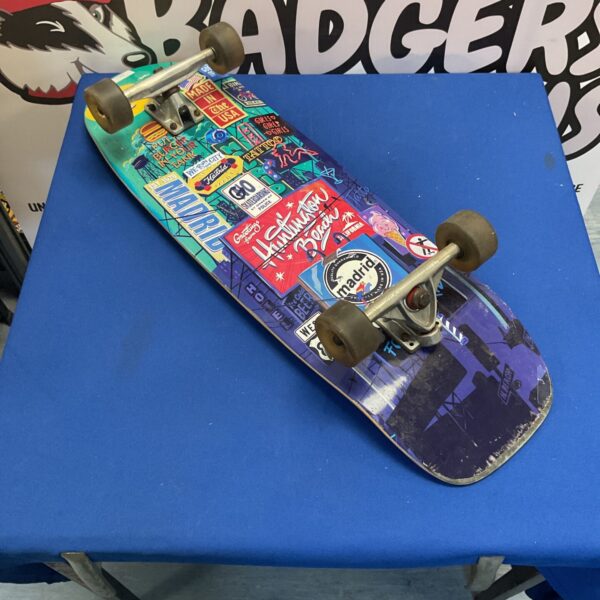 Vintage retro cruiser skateboard with checkered grip tape.