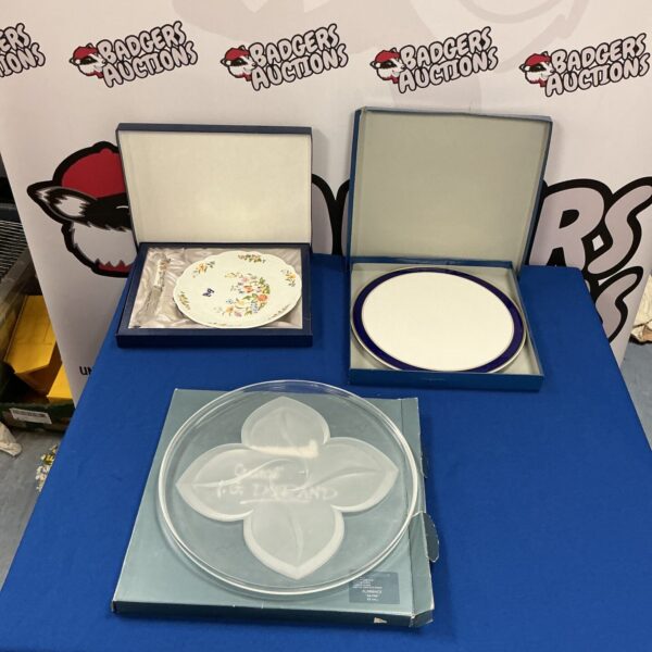 Vintage Aynsley collectors plates with floral designs for display.