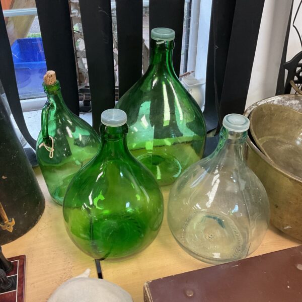 Three green and clear glass gourd bottles for display.