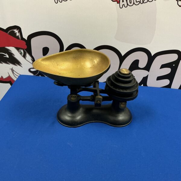 Vintage kitchen balance scales with brass pans for weighing.