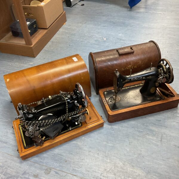 Antique Singer and Harris sewing machines in a vintage condition.