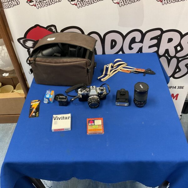 Vintage Olympus OM10 camera kit with flash and skylight filter.