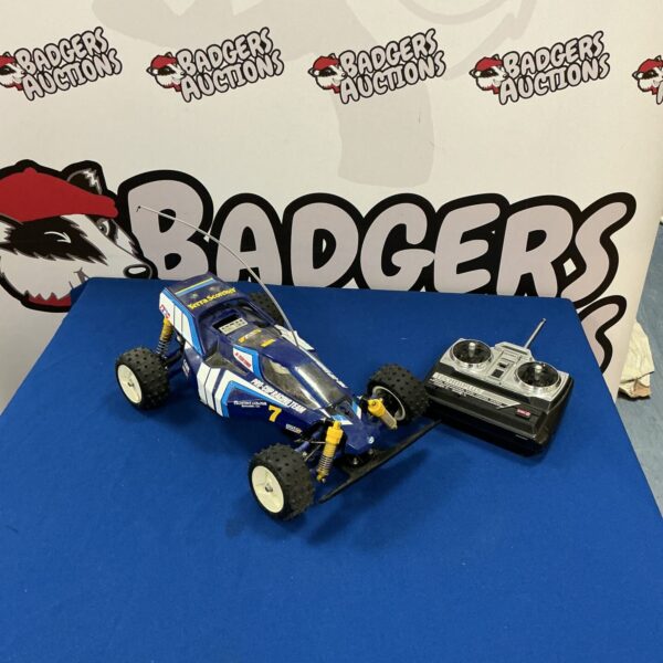 Blue vintage RC car with remote control unit.