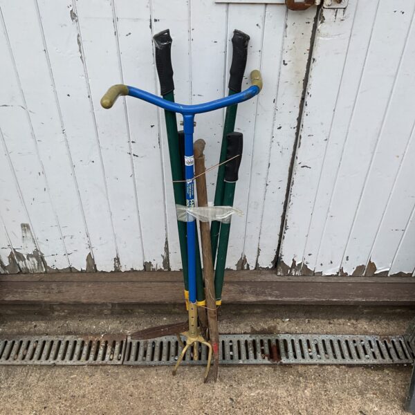 Vintage multi-tool garden tool with wooden handle and metal head.