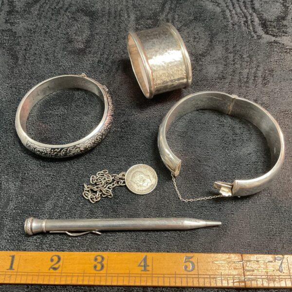 Vintage silver lot including bracelets, chain, and napkin ring.