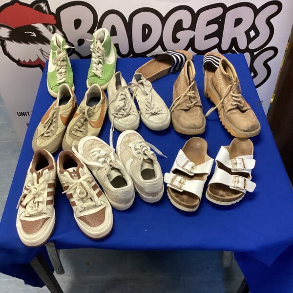 Mixed lot of Nike and Converse trainers and sliders for sale.