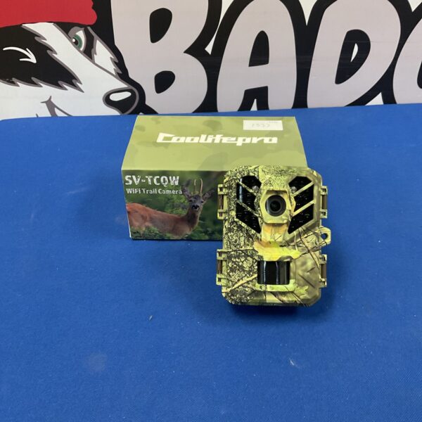 Camouflaged Coolife pro SV-TCOW trail camera for wildlife observation.