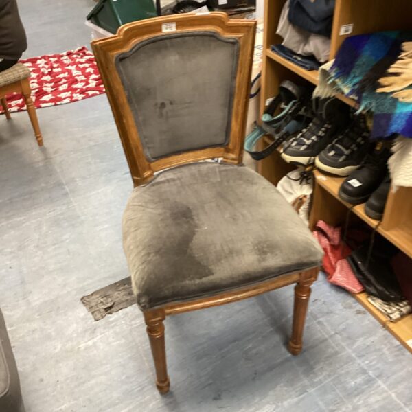 Grey upholstered vintage bedroom chair with wooden frame.