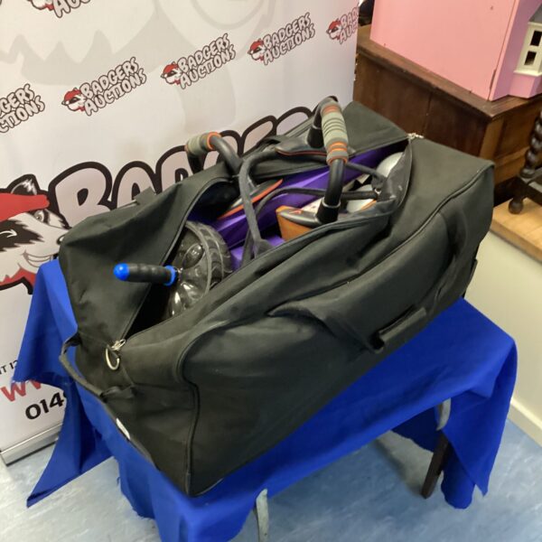Fitness equipment lot including a yoga mat and exercise tools.