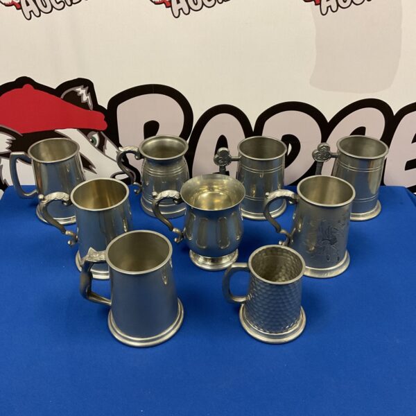 Collection of antique pewter tankards for sale.