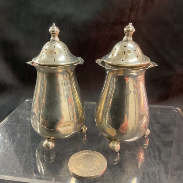 Vintage sterling silver salt and pepper pots with pierced tops.