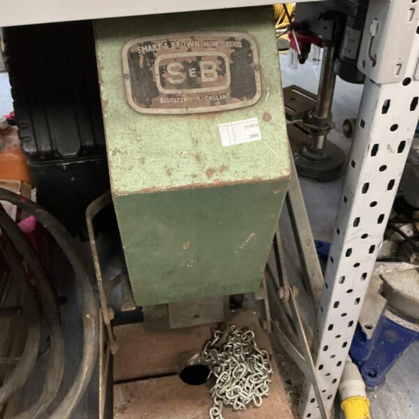 Vintage Smart and Brown pressing machine in a workshop setting.