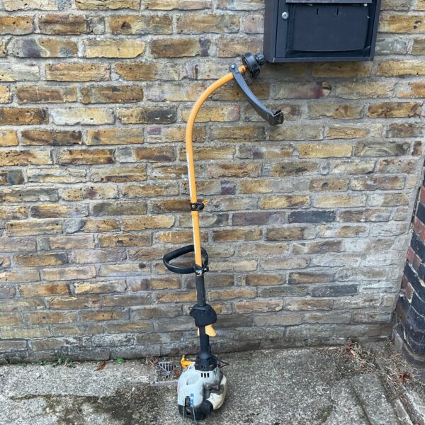Ryobi PLT 25431 petrol strimmer for garden landscaping.