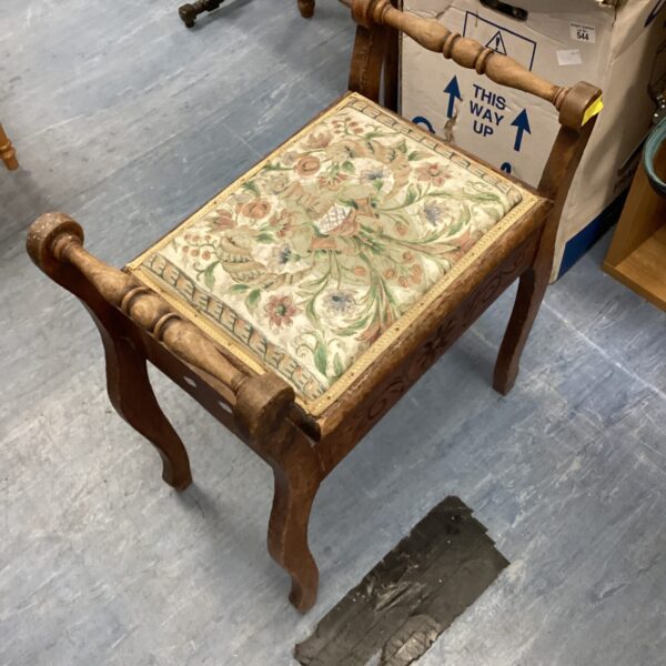 Vintage sewing stool with detailed needlepoint upholstery and storage.