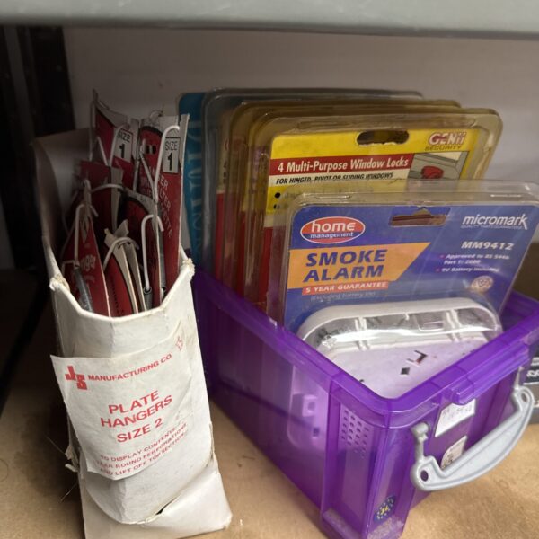 Lot of smoke alarms, window locks, and decorative plate hangers.