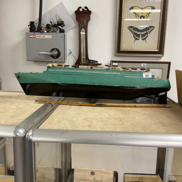 Vintage RMS Caronia model ship needing restoration.