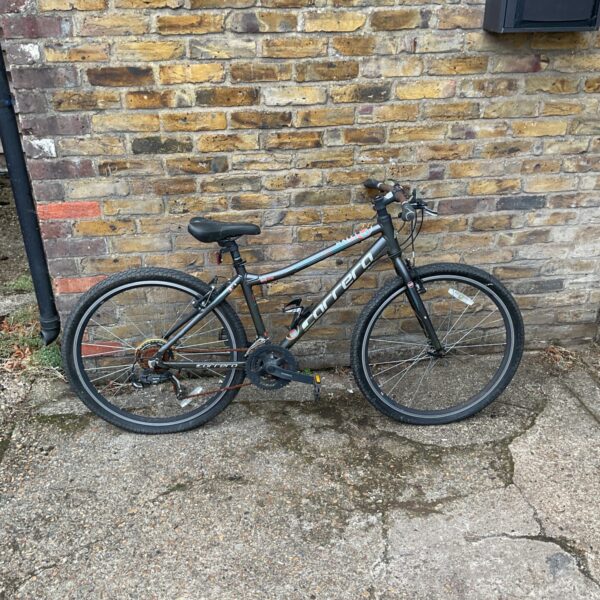 Side view of a grey Carrera Axle LTD mountain bike.
