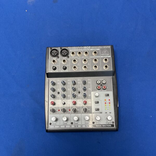 Behringer Xenyx 802 audio mixer with eight input channels.