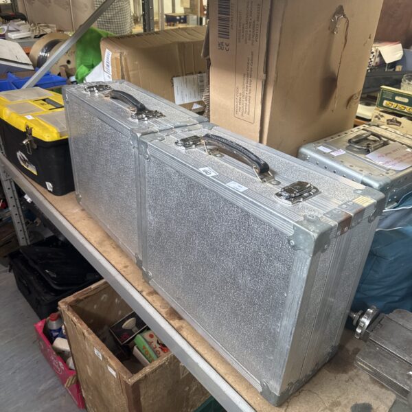 Two DJ turntable flight cases showing signs of wear.