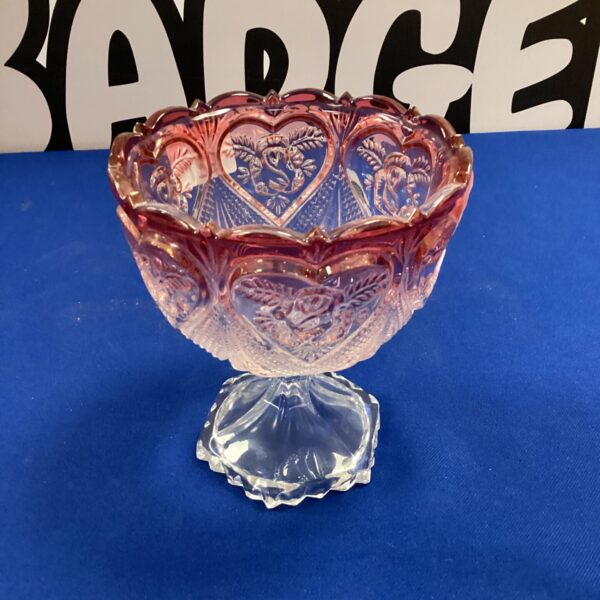 Antique cranberry glass pedestal vase with scalloped bowl.