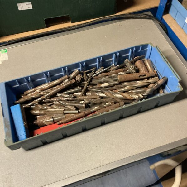 Tray of assorted drill bits for metalworking and DIY projects.