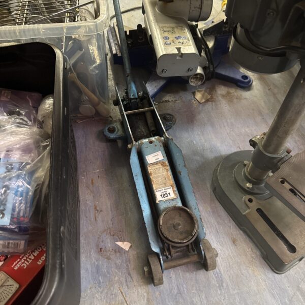 Small hydraulic trolley jack for automotive lifting and repair.