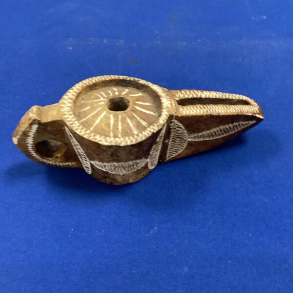 Antique Middle Eastern stone oil lamp with carved details.