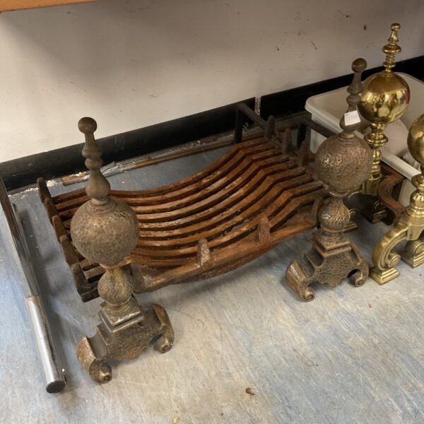Antique cast iron fire grate with decorative firedogs for a Victorian fireplace.