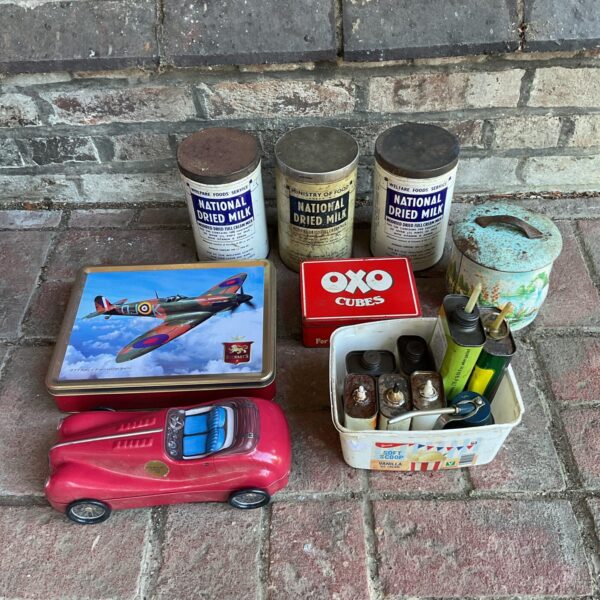 Vintage collection of tin and oil cans, including National Dried Milk.
