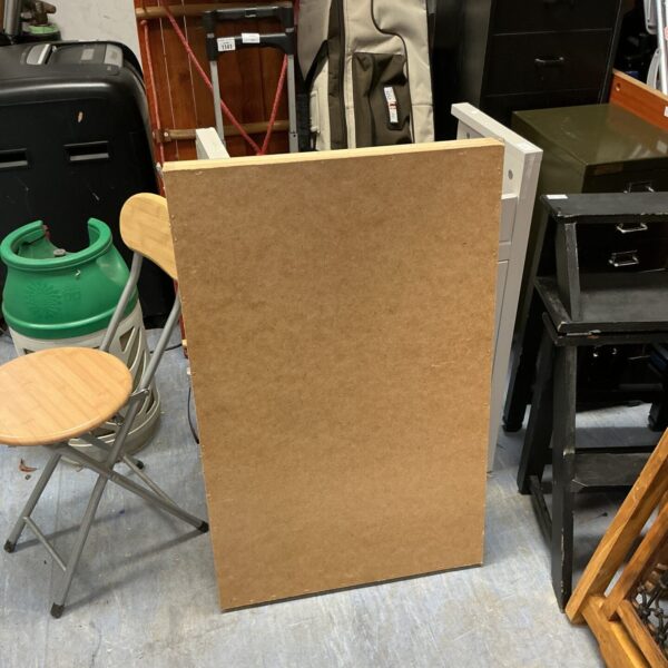 Vintage folding pasting table in a workshop setting.