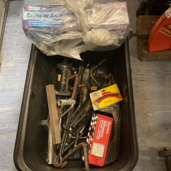 Vintage car jack and battery charger lot for vehicle maintenance.