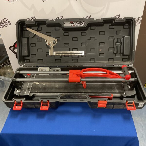 Large commercial tile cutter with scoring wheel visible.