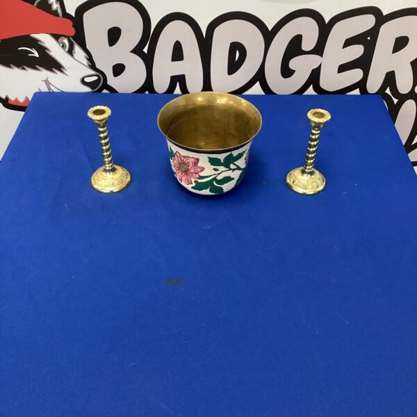 Gilded brass candlesticks and Indian brass pot on display.