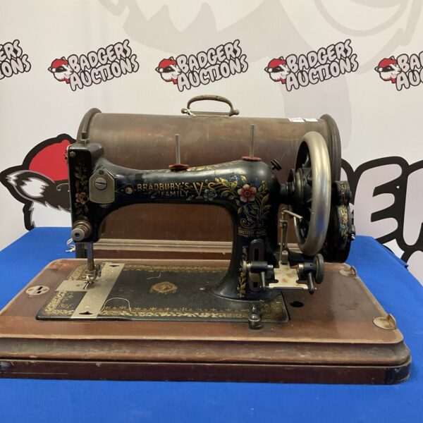 Antique Bradbury family sewing machine with ornate detailing.