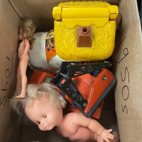 Vintage toy lot featuring dolls and diecast vehicles.