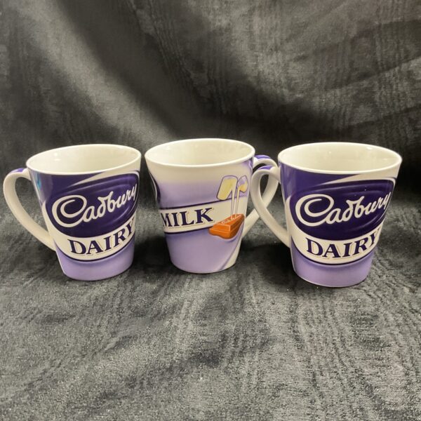 Lot of three Cadbury Dairy Milk branded ceramic mugs.