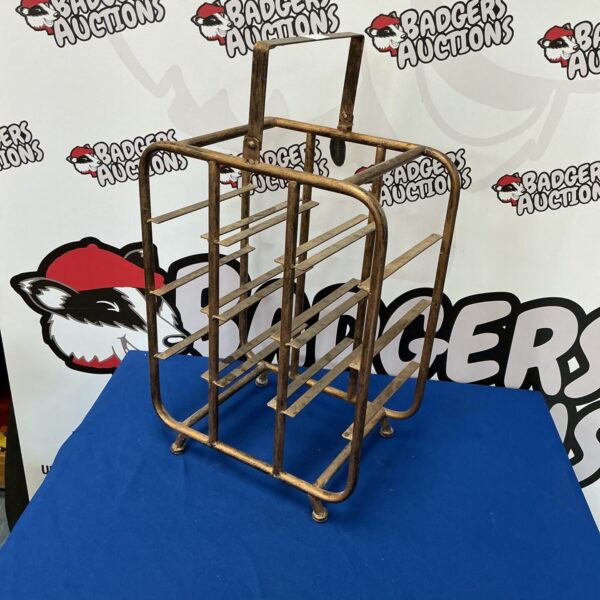 Vintage metal wine rack for storing wine bottles.