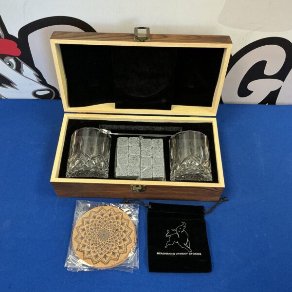 Open whisky stone set case with glasses and stones visible.